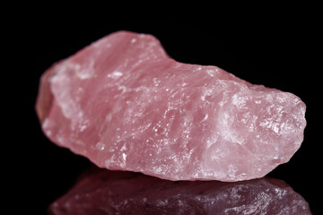 Macro mineral stone Pink quartz on black background