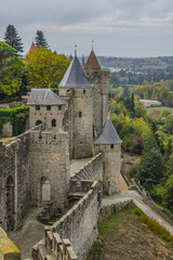 Fototapeta na wymiar Carcassonne Cite is a hilltop town ringed by two concentric walls, hosting 52 defensive towers. Carcassonne Cite - largest walled city in Europe. Carcassonne, Languedoc, region of Occitanie, France.