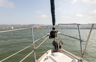 View of the embankment and the Downtown from the View from the bow of the yacht in the Haifa Bay, in the Mediterranean Sea, near the port of Haifa in Israel