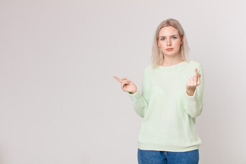 blond pretty woman feeling angry, annoyed, rebellious and aggressive