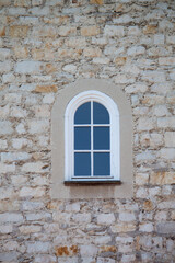 Fototapeta na wymiar window in the wall of an old stone castle