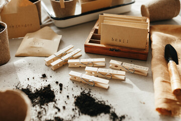 Seeds, peat pots, gardening tools on linen fabric background. Ready for plant
