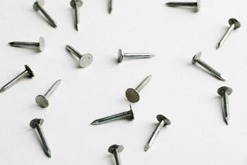 Metal nails close up, lots of nails on a white background.