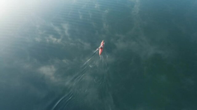 4K Drone footage of young  Indian kayaking in a misty lake in Kotagiri, Nilgiris, Chennai Tamil Nadu, India 60FPS for slow motion