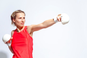 Portrait of Active Caucasian Boxer During Regular Boxing Physical Exercises In White Gloves On White Background.