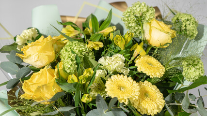 Colorful flower bouqet arrangement. Summer flowers held by florist in hand close up. Flowers for wedding and happy occasions.