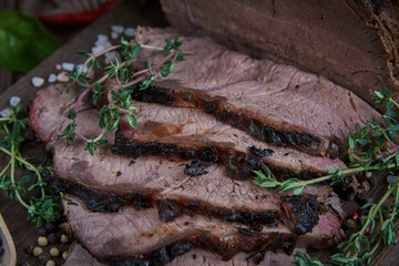 Roast beef on cutting board. Wooden background.