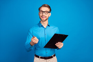 Naklejka na ściany i meble Photo of young man happy positive smile hold clipboard interview hiring hr isolated over blue color background
