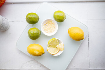 Bowl of vitamins and a bowl of lemon and lime slices