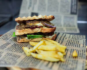 Sausage dagwood on faux newspaper