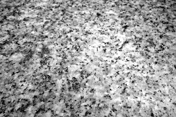 Granite surface as background with blur effect in black and white.