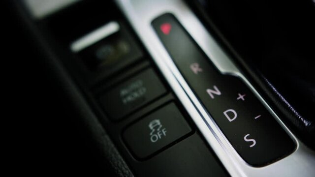Man shifting gear, Close up of hand on automatic modern gear