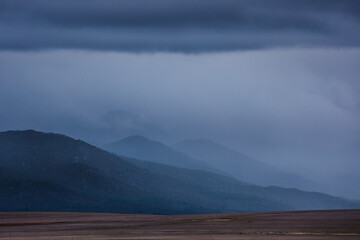 Distant mountains covered in mist and clouds