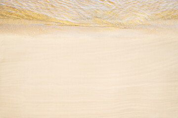 Top and aerial view on tropical sand beach with yellow sea. Ocean coastline. Drone photo. Background