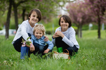 Fototapeta premium Happy children of different age groups, running together in the park, springtime, having fun