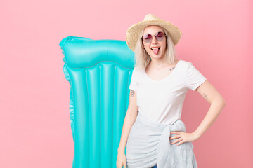 blond pretty woman with cheerful and rebellious attitude, joking and sticking tongue out. summer...