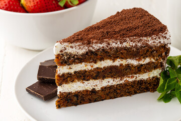 Piece of chocolate cake on table close up