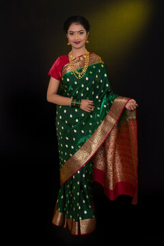 Indian model wearing traditional Maharashtrian bridal green sari and jewelry. Looking at Camera. Full length shot