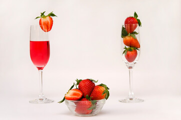 strawberries in a bowl and a glass with a strawberry drink
