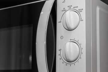 Close-up Control Panel of White Microwave in Kitchen, for Set the Temperature and Cooking Time.