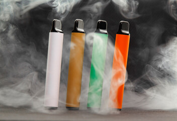 E-cigarettes on dark background in smoke, mocap