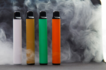 E-cigarettes on dark background in smoke, mocap