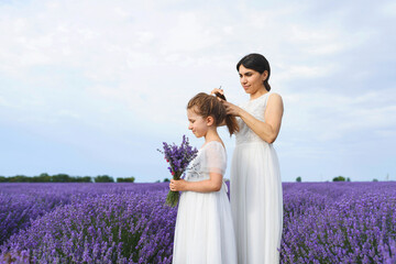 mother fixing daughter's hair in lavender