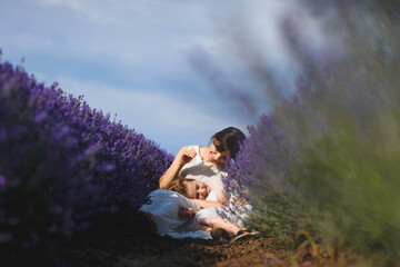 daughter laying on mother's knees in lavender