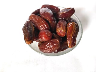 selectively focus on dates fruit (Phoenix dactylifera) isolated on a white background. fasting food