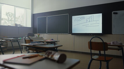 Empty classroom interior. School room with modern projector screen on wall