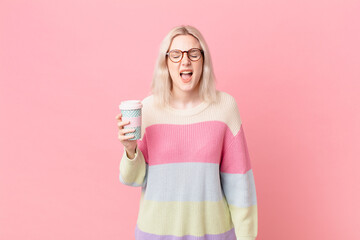 blond pretty woman shouting aggressively, looking very angry. coffee concept