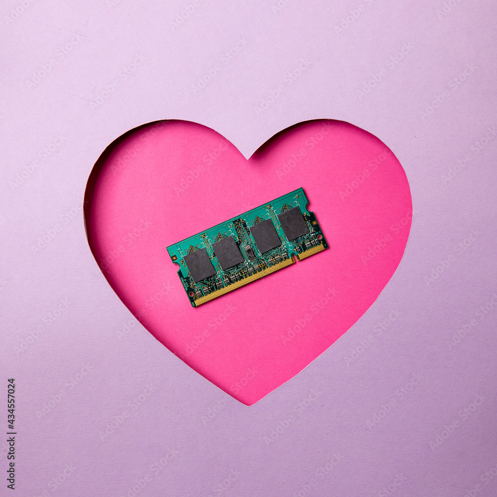 Fototapete pink heart shape on a purple background. at the heart are a memory frame for a computer and laptop. 