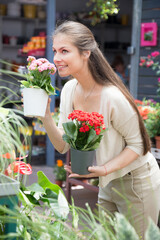 nice european girl looking at flowers in shop