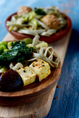 vegan dishes, with tofu dice and mock meatballs