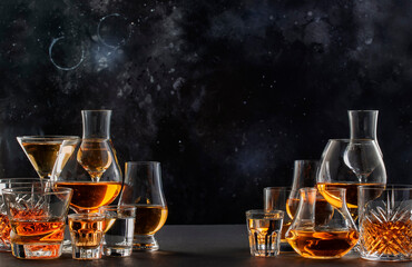 Hard strong alcoholic drinks, spirits and distillates in glasses in assortment: vodka, cognac,...