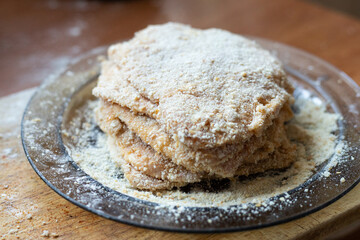 Breaded pork chop lying on a plate. Traditional dinner.