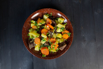plate with stew cooked of vegetables and beeaf