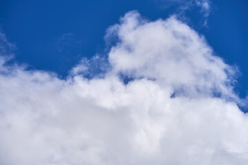 clouds float across the blue sky