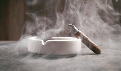  Cigar and ashtray on table. Smoking