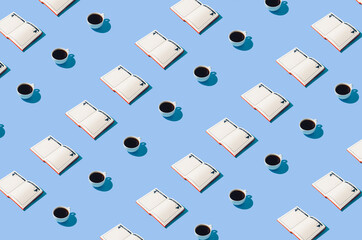 Creative concept with open notebooks and coffee cups on pastel blue background. Authentic minimal pattern idea.
