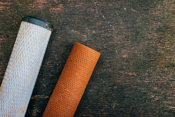 Top view of used rust filled home water filters or cartridges from domestic osmosis systems on dark...