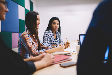 Thoughtful colleagues working together in modern office during meeting