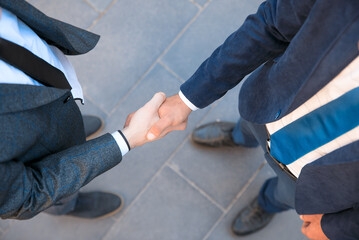 Handshake of two young businessmen