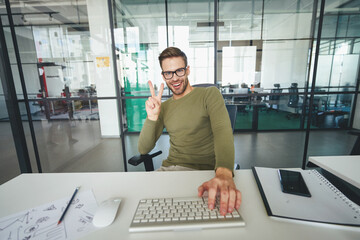 Young man gesturing actively in front of a web-camera