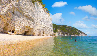 Mighty and white rock walls protecting famous Baia delle Zagare (Zagare Bay) or Baia dei Mergoli...
