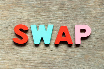 Color alphabet letter in word swap on wood background