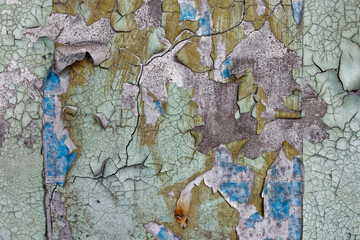 Old cracked wallpaper on concrete wall