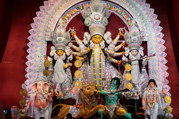 Fototapeta na wymiar Idol of Goddess Devi Durga at a decorated puja pandal in Kolkata, West Bengal, India. Durga Puja is a famous and major religious festival of Hinduism that is celebrated throughout the world.