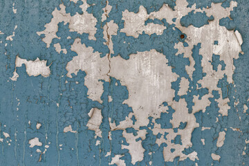 Blue cracked wallpaper on concrete wall