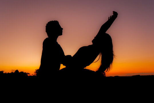 silhouette performing ballet dancer at the sunset. women  and man couple 